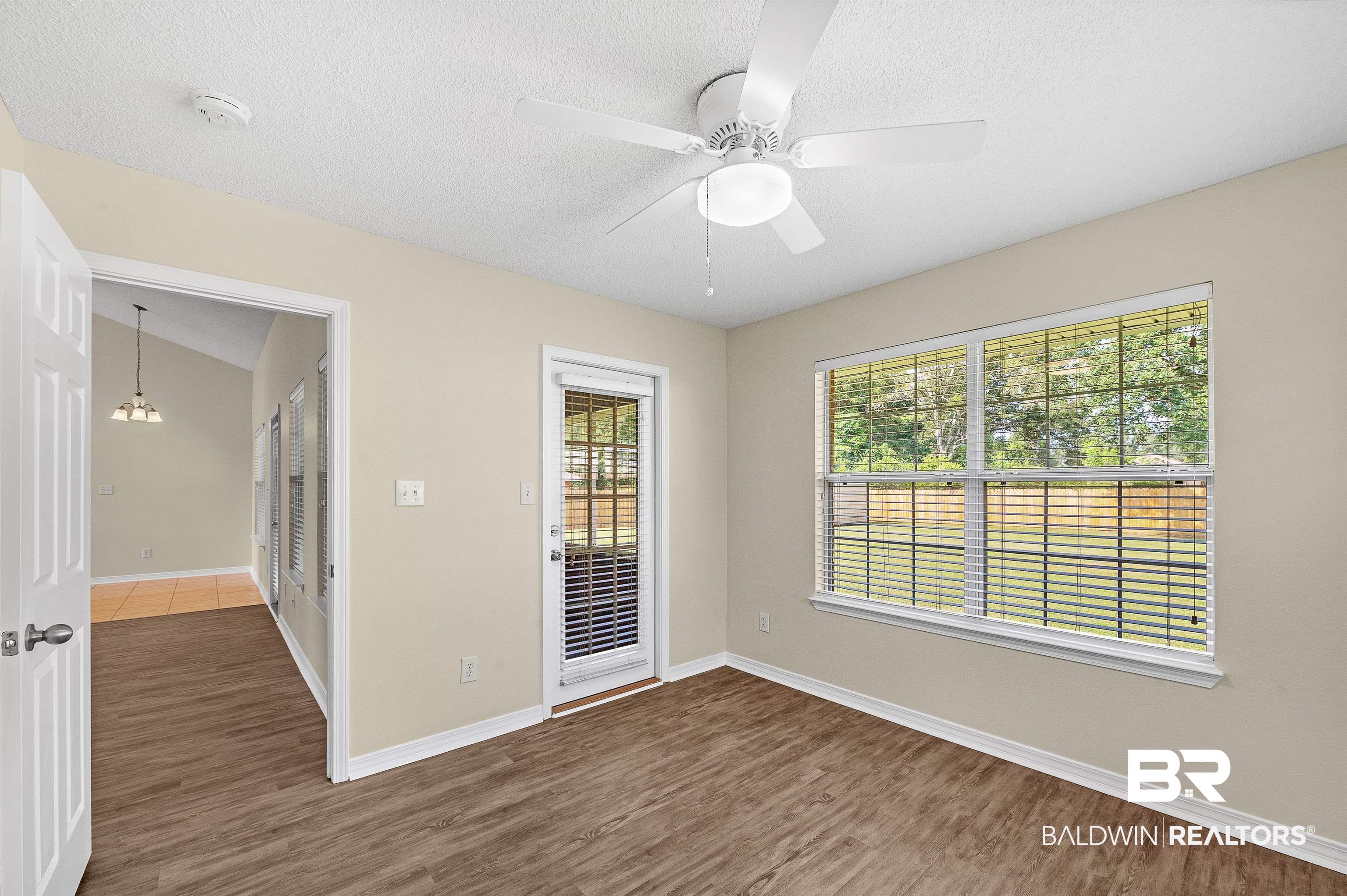 12443 Venice Boulevard Foley, AL 36535 - Photo 57 of 59 Unfurnished room with dark wood-type flooring, a textured ceiling, vaulted ceiling, and ceiling fan