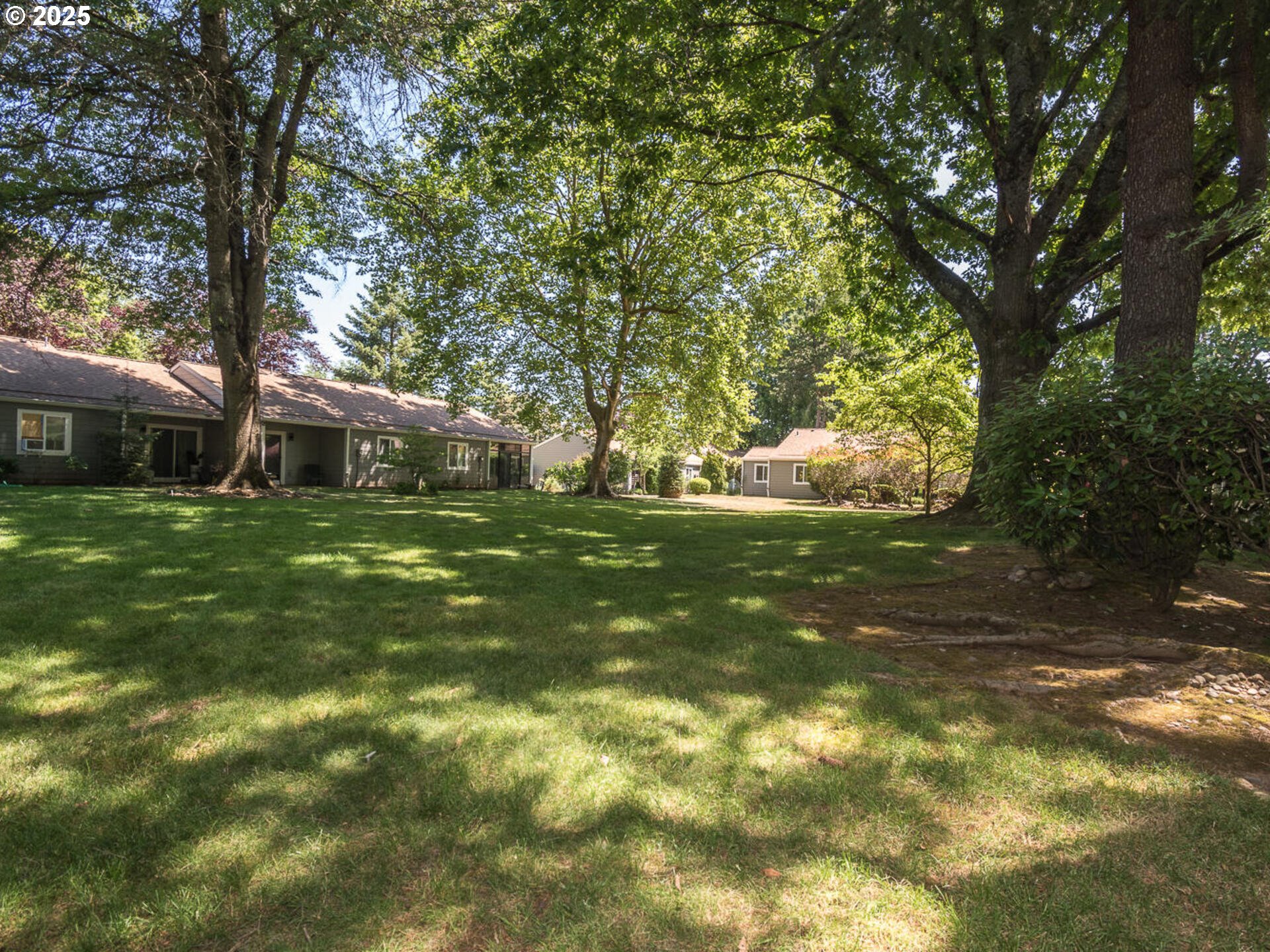 2712 Southeast 138th Avenue, Unit 53 Portland, OR 97236 - Photo 27 of 36 a view of a house with a tree in a yard
