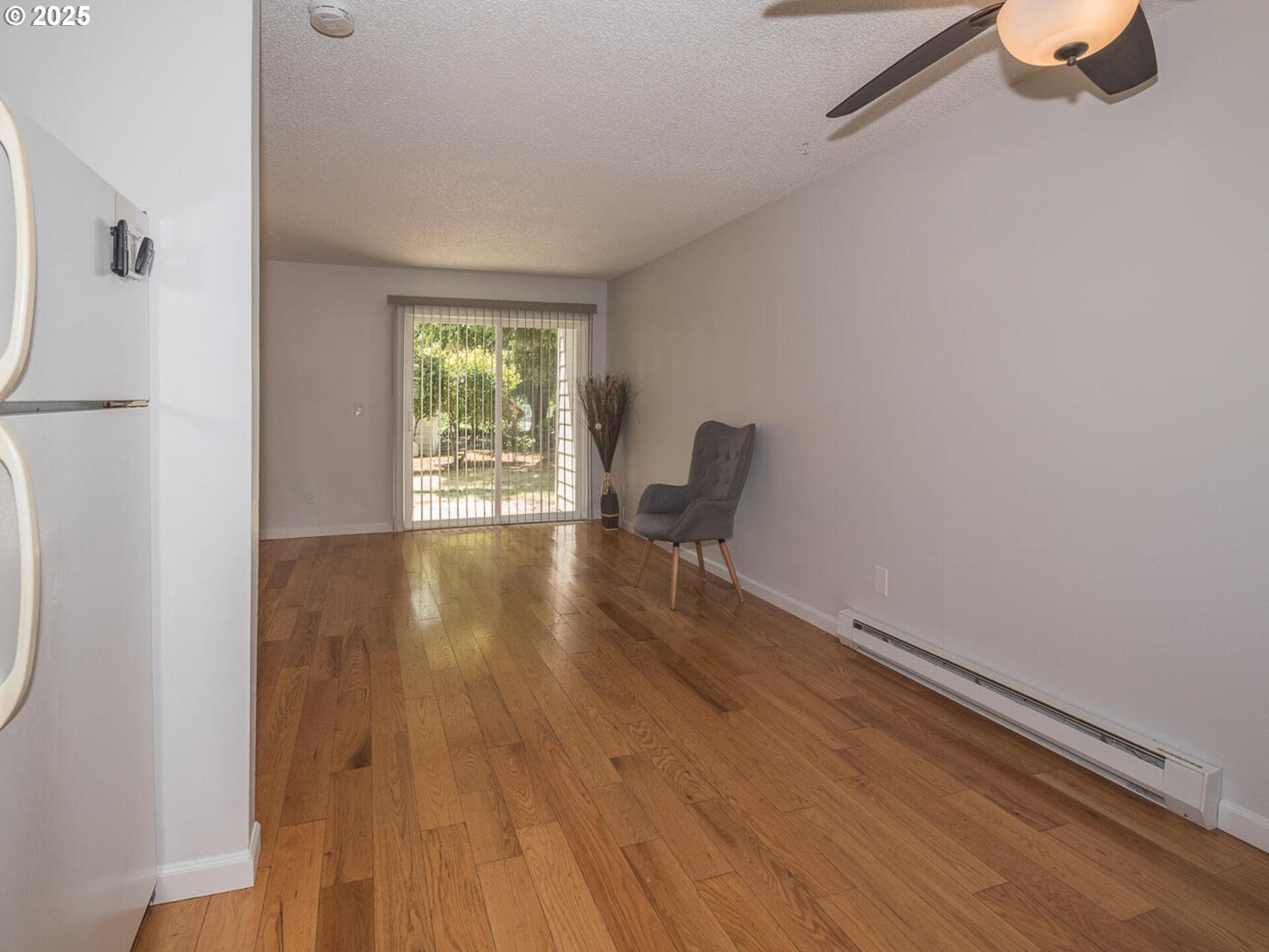 2712 Southeast 138th Avenue, Unit 53 Portland, OR 97236 - Photo 8 of 36 a view of room with wooden floor lounge chair and windows