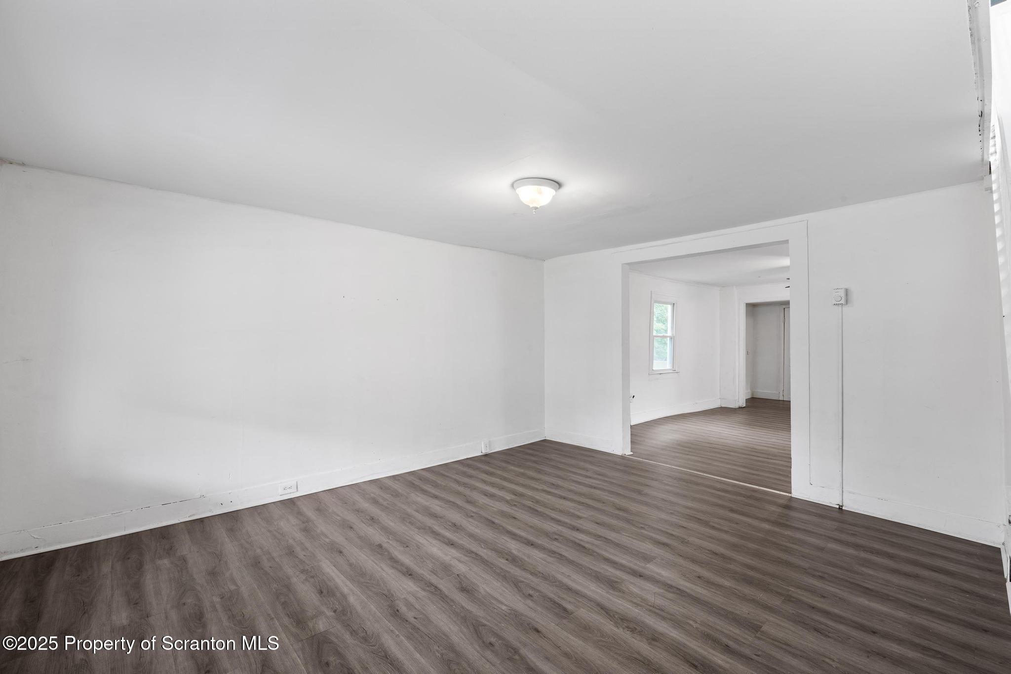 121 Throop Street Scranton, PA 18508 - Photo 14 of 37 a view of an empty room with wooden floor