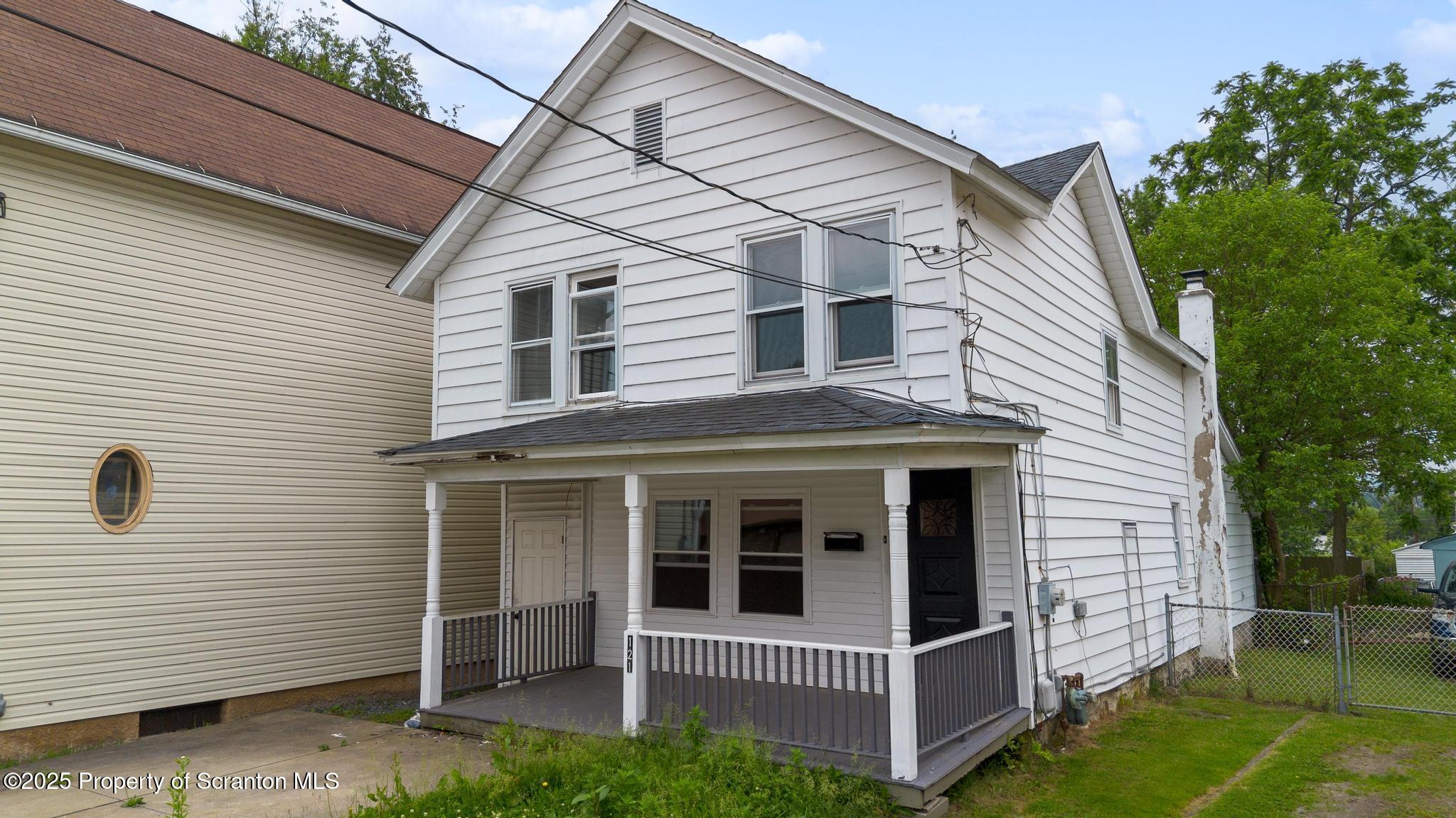 121 Throop Street Scranton, PA 18508 - Photo 2 of 37 a view of a white house with a small yard and wooden fence
