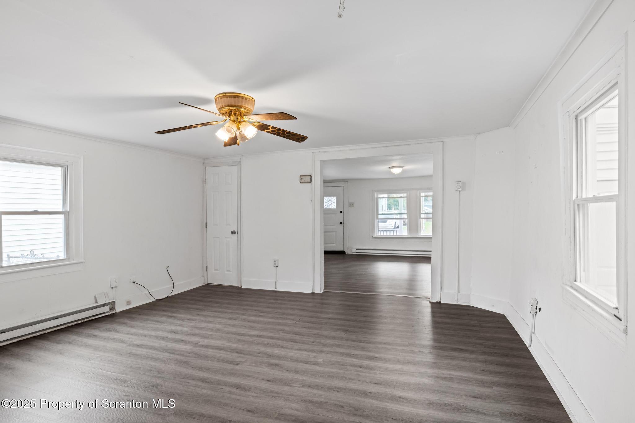 121 Throop Street Scranton, PA 18508 - Photo 23 of 37 an empty room with wooden floor and windows