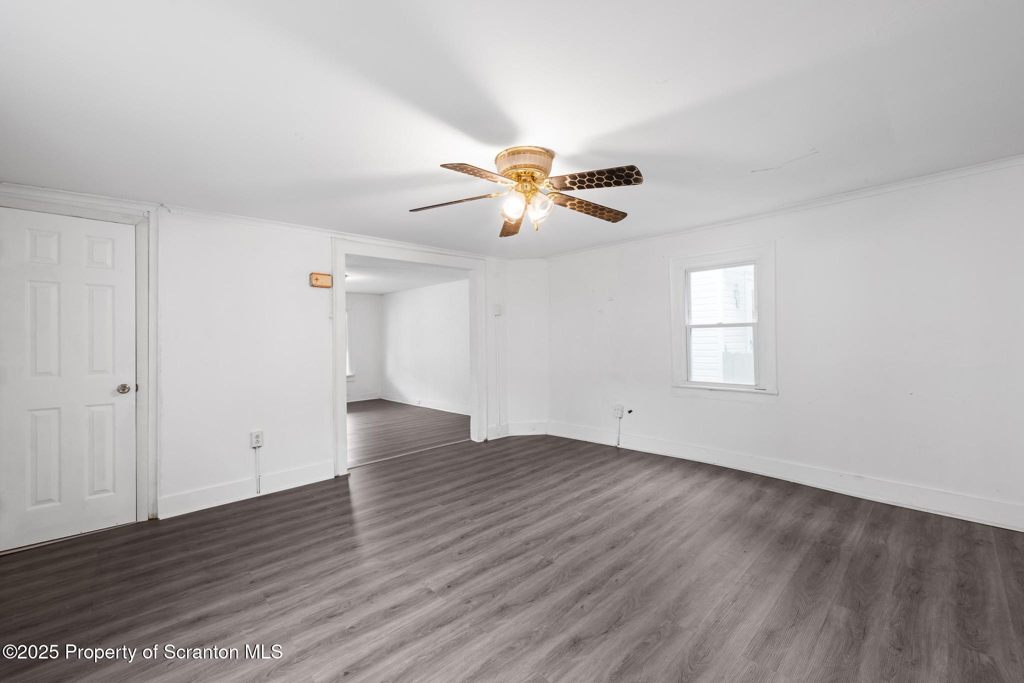 121 Throop Street Scranton, PA 18508 - Photo 24 of 37 a view of an empty room with window and wooden floor