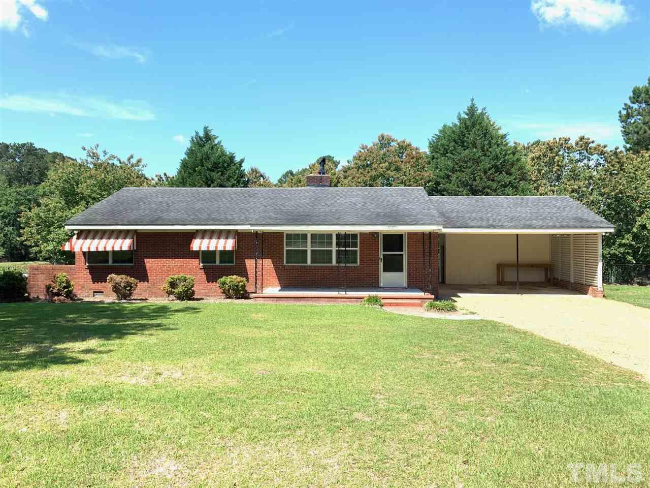 3539 Meadowlark Road Dunn, NC 28334 - Photo 1 of 25 a front view of a house with a yard and garage