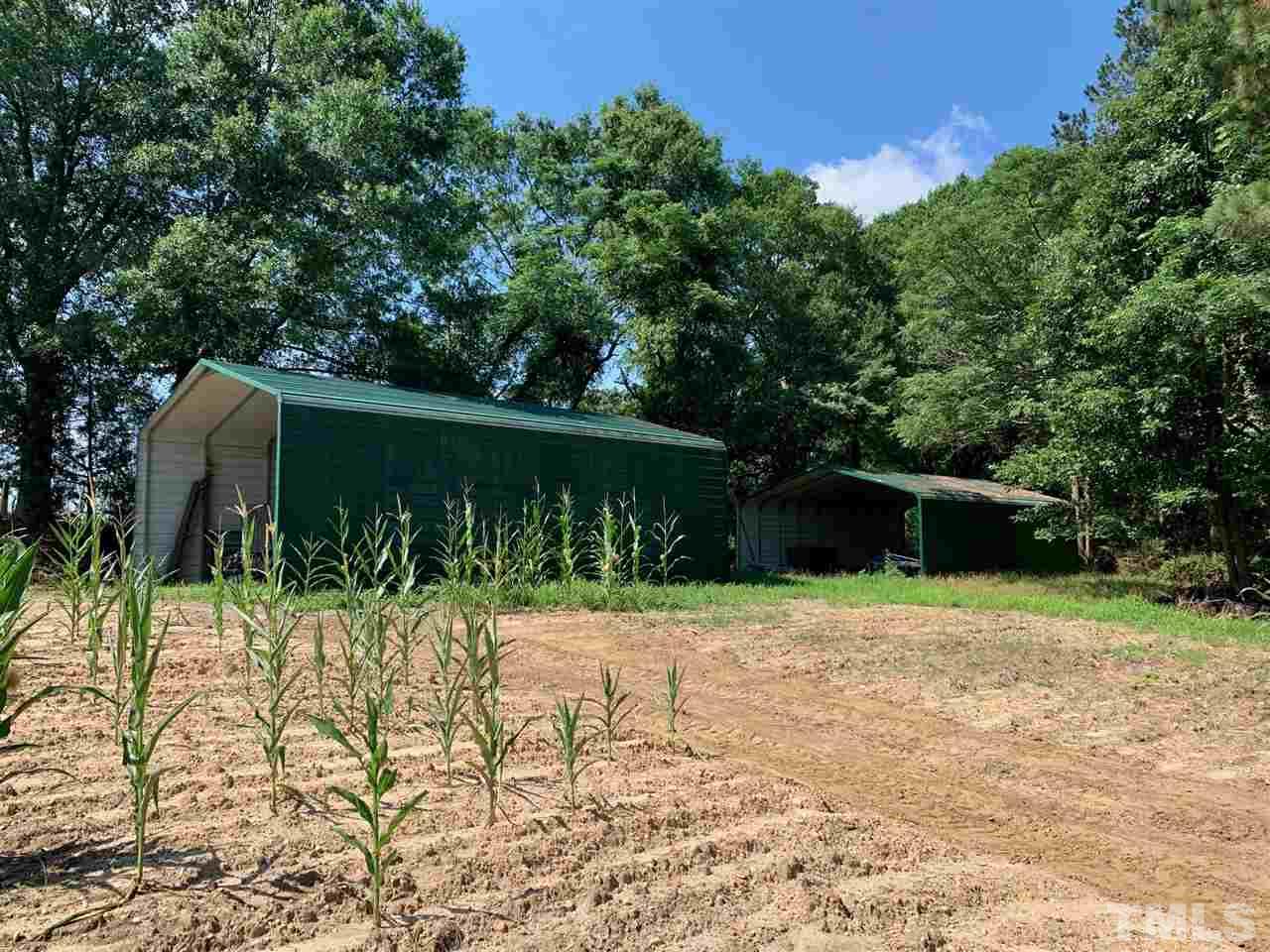 3539 Meadowlark Road Dunn, NC 28334 - Photo 19 of 25 a backyard of a house with lots of green space and trees