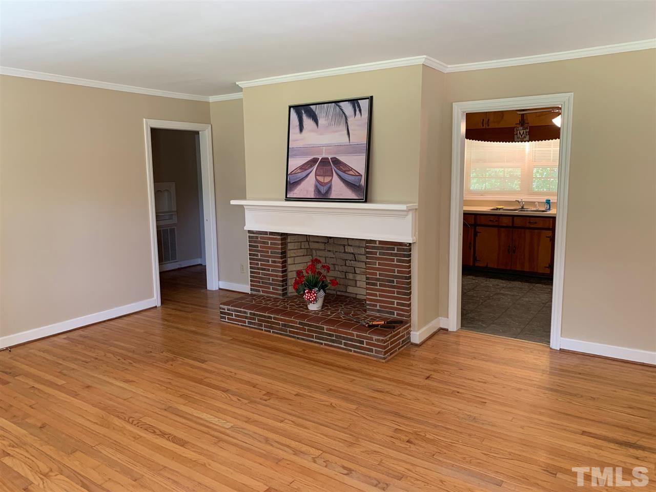 3539 Meadowlark Road Dunn, NC 28334 - Photo 4 of 25 a view of an empty room with wooden floor fireplace and a window
