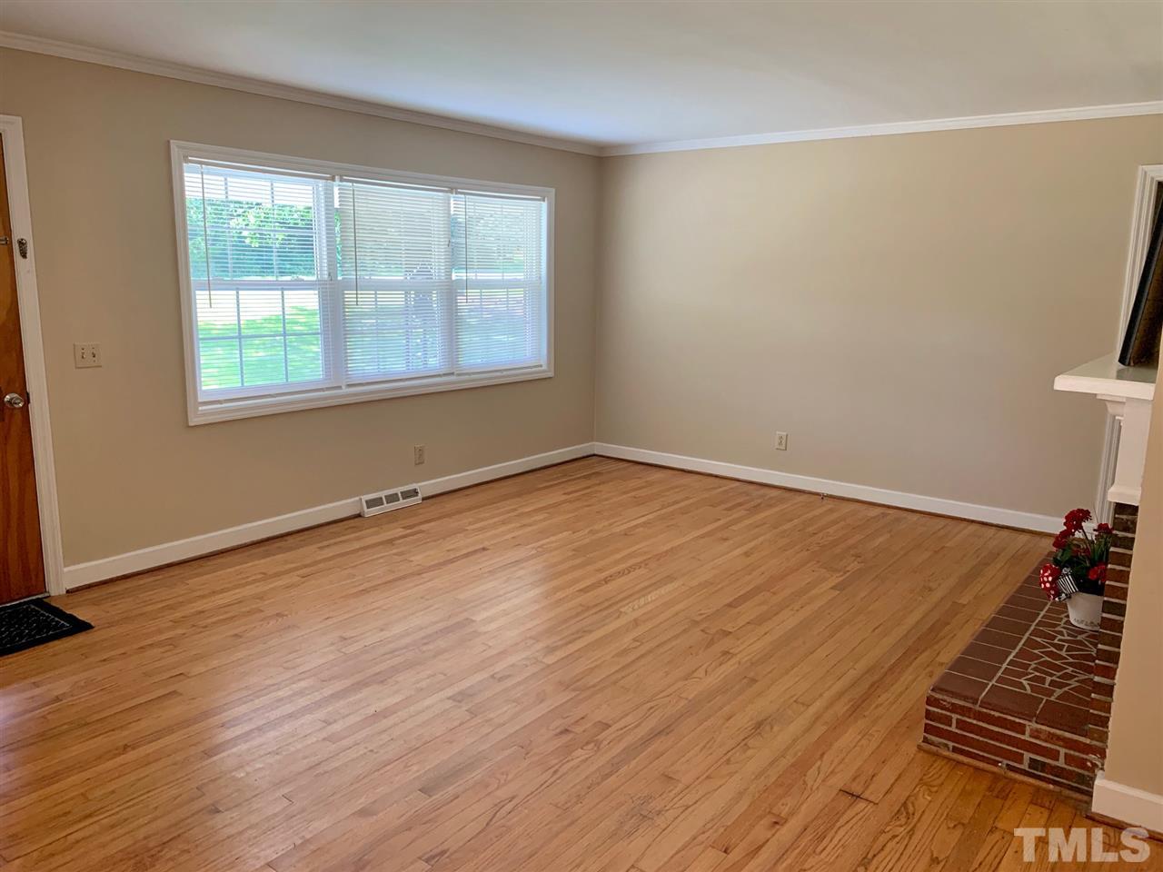 3539 Meadowlark Road Dunn, NC 28334 - Photo 6 of 25 an empty room with wooden floor and windows