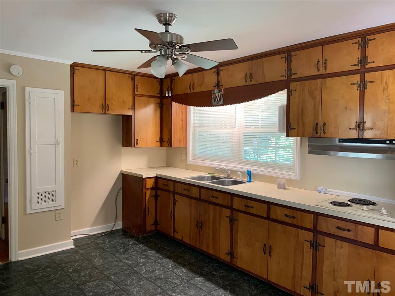 3539 Meadowlark Road Dunn, NC 28334 - Photo 7 of 25 a kitchen with stainless steel appliances granite countertop a sink a stove and a refrigerator
