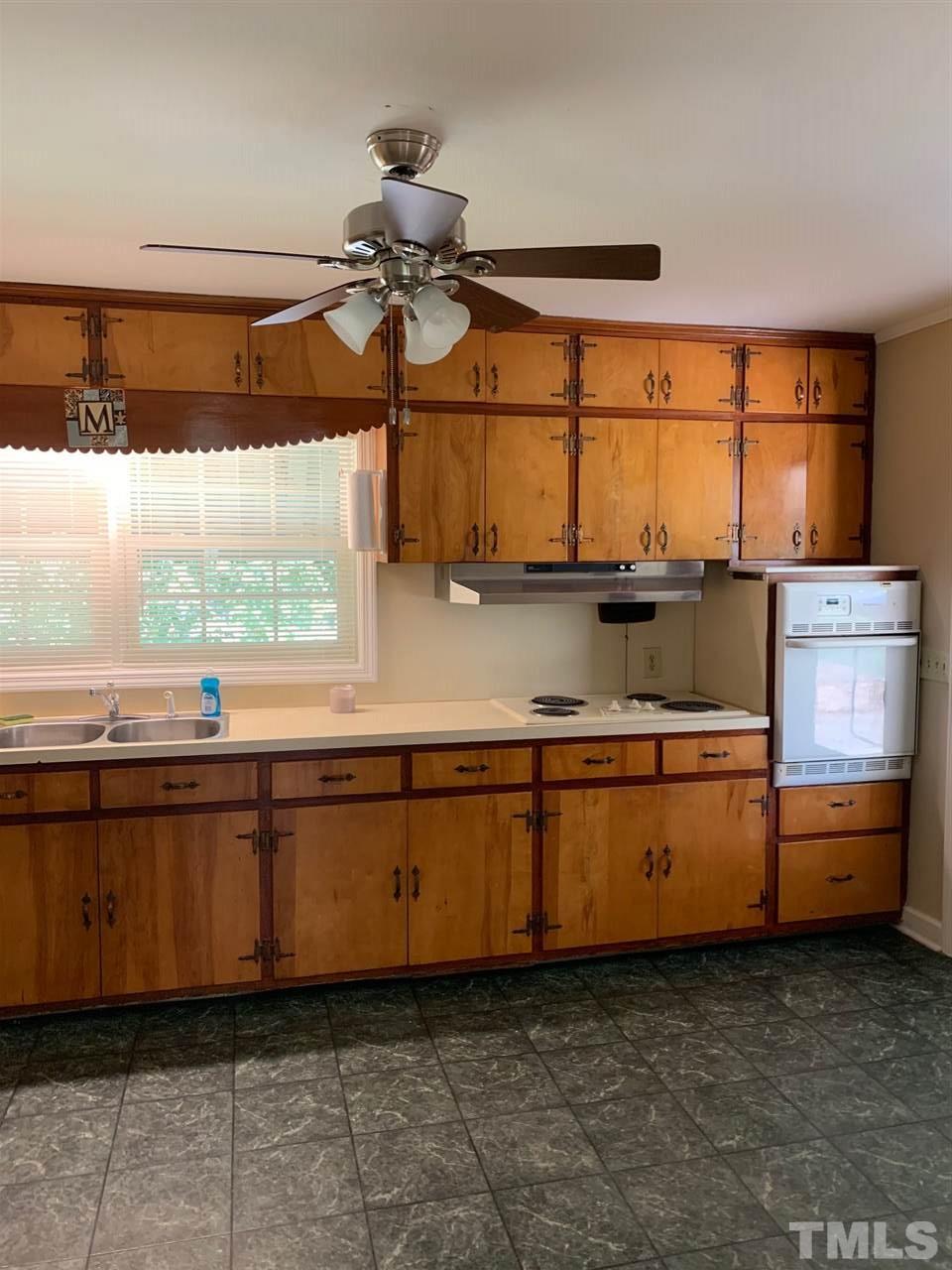 3539 Meadowlark Road Dunn, NC 28334 - Photo 8 of 25 a kitchen with granite countertop a stove and a sink