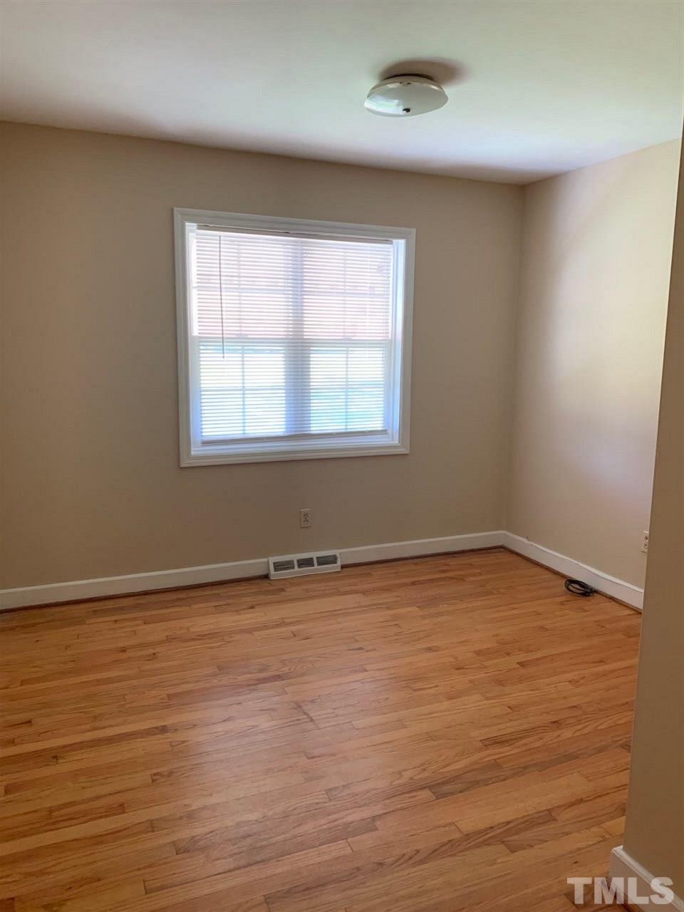 3539 Meadowlark Road Dunn, NC 28334 - Photo 9 of 25 wooden floor in an empty room with a window