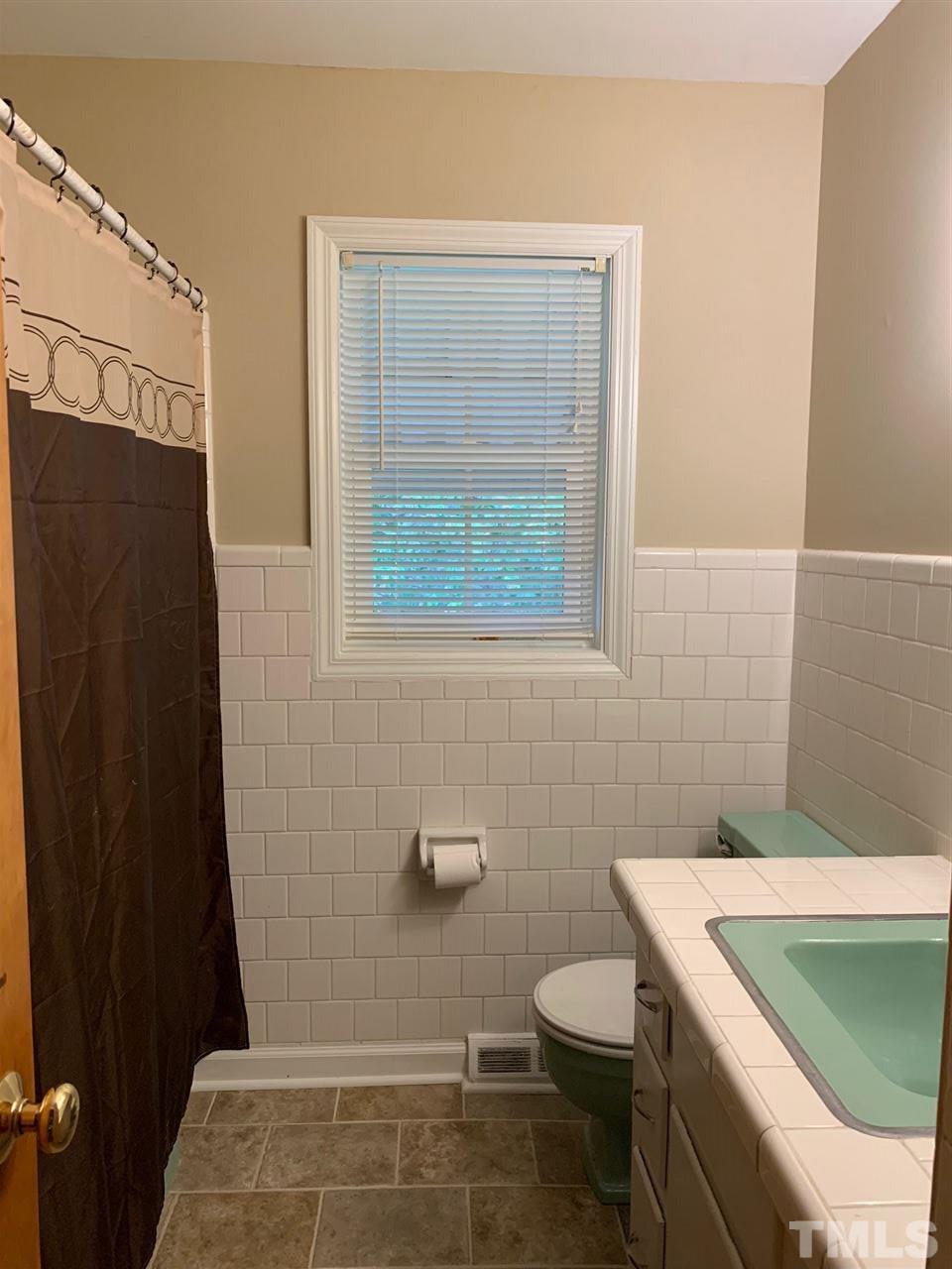 3539 Meadowlark Road Dunn, NC 28334 - Photo 10 of 25 a bathroom with a granite countertop sink toilet and shower