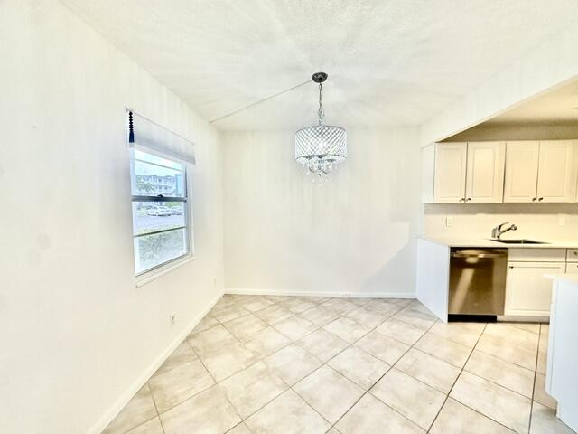 1047 Exeter C Boca Raton, FL 33434 - Photo 6 of 37 a view of a kitchen with a stove cabinets and a window