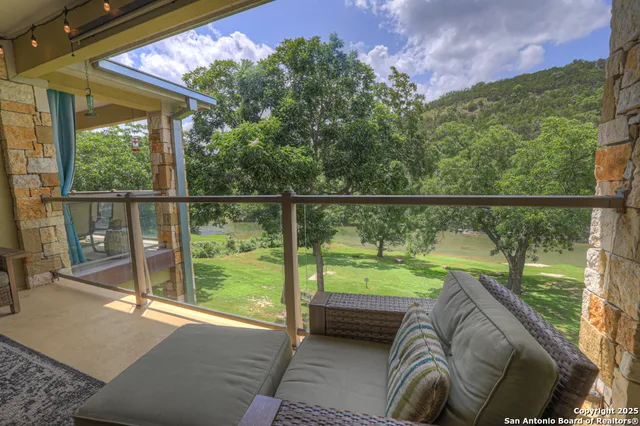 a view of a balcony with yard