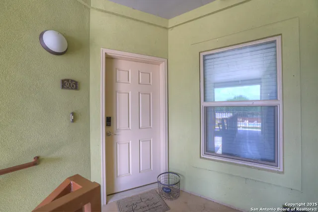 a view of a hallway with front door