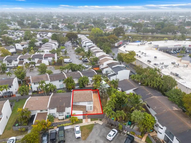an aerial view of residential houses with outdoor space