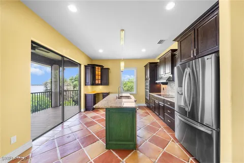 a kitchen with stainless steel appliances granite countertop a refrigerator and a sink
