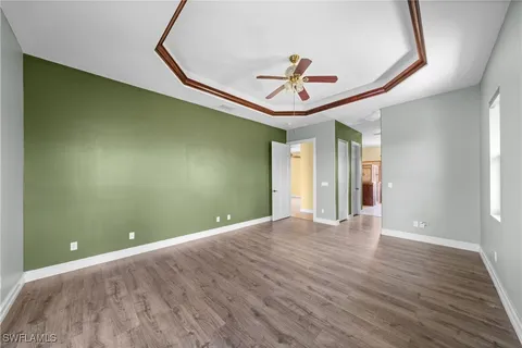 a view of a livingroom with a ceiling fan and hardwood floor