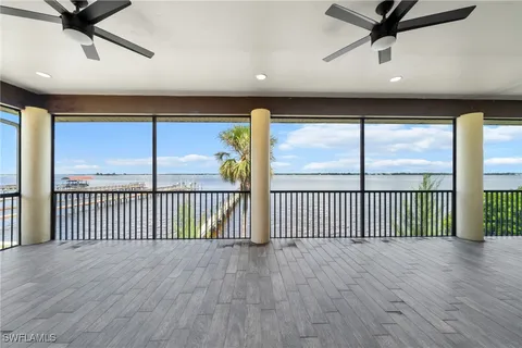 a view of a room with wooden floor and windows