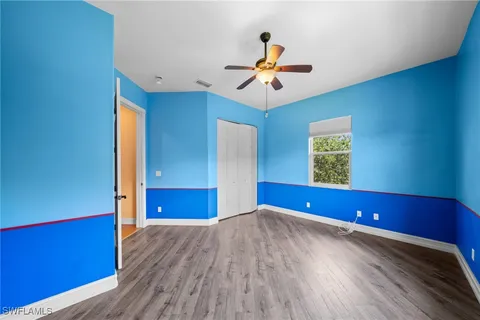 a view of a room with wooden floor and window