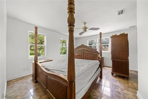 a bed room with a bed and a window