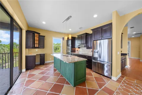 a kitchen with stainless steel appliances granite countertop a refrigerator and a stove
