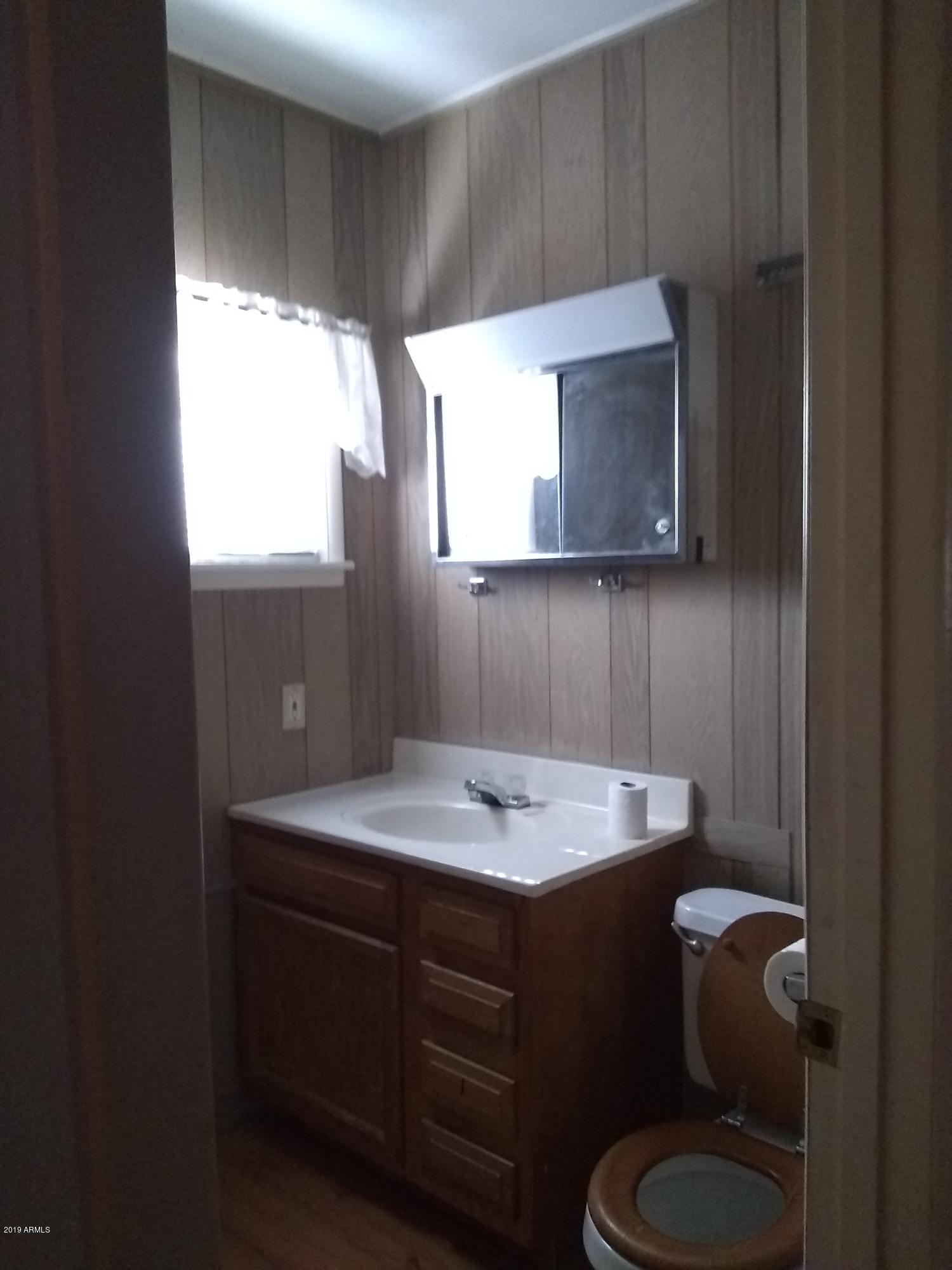 6137 B Street Lakeside, AZ 85929 - Photo 15 of 16 a bathroom with a sink toilet and mirror