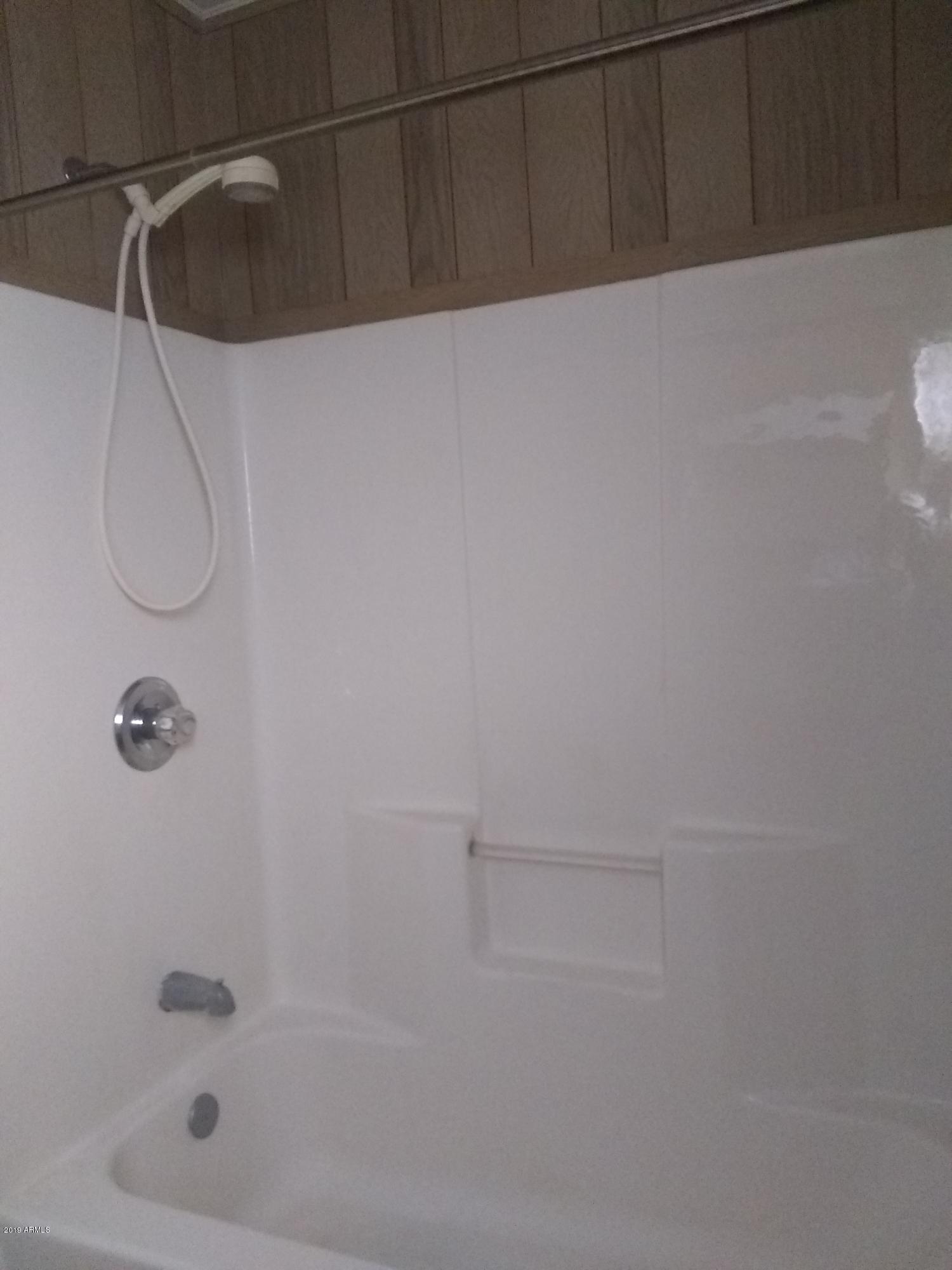 6137 B Street Lakeside, AZ 85929 - Photo 16 of 16 a bathroom with a shower and a bath tub