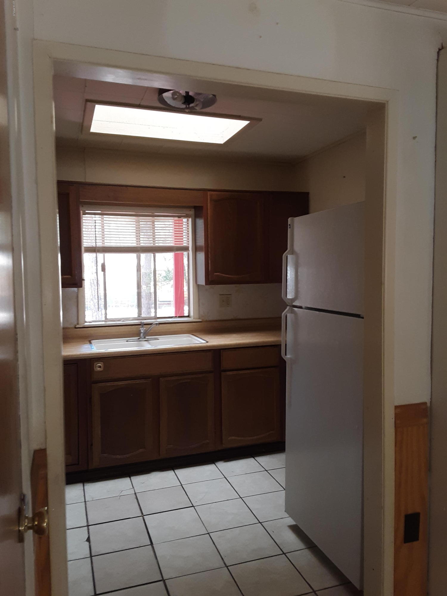6137 B Street Lakeside, AZ 85929 - Photo 8 of 16 a kitchen with a refrigerator and window
