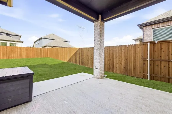 a view of backyard with tub and wooden fence