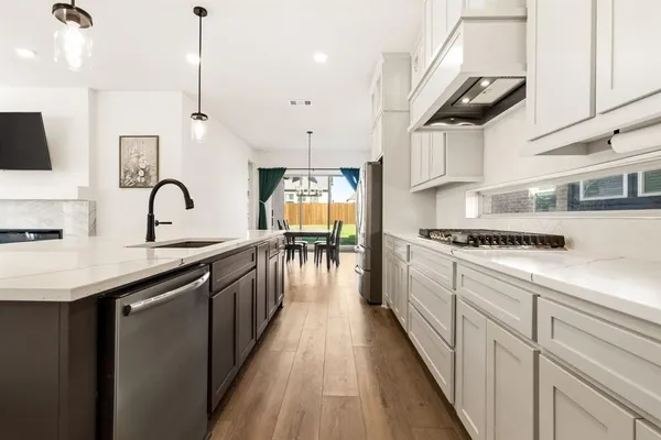 a kitchen with kitchen island granite countertop lots of counter top space and stainless steel appliances