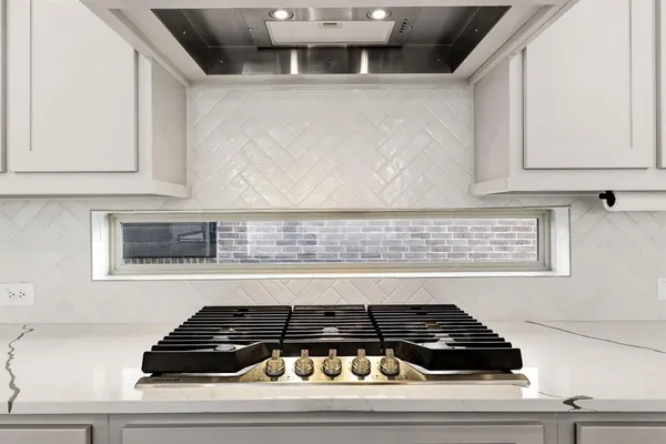 a kitchen with granite countertop a stove and a cabinet