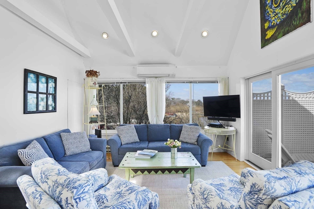 31 The Boulevard Edgartown, MA 02539 - Photo 12 of 39 a living room with furniture a flat screen tv and a large window