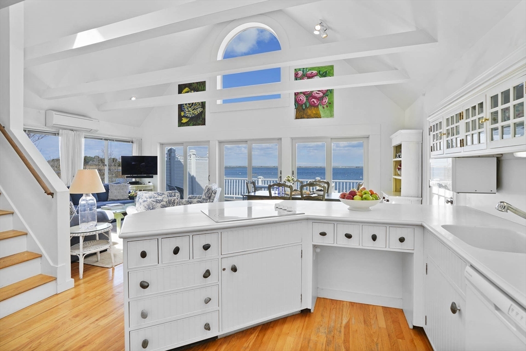 31 The Boulevard Edgartown, MA 02539 - Photo 13 of 39 a kitchen with stainless steel appliances a sink dishwasher and a flat tv screen next to a window
