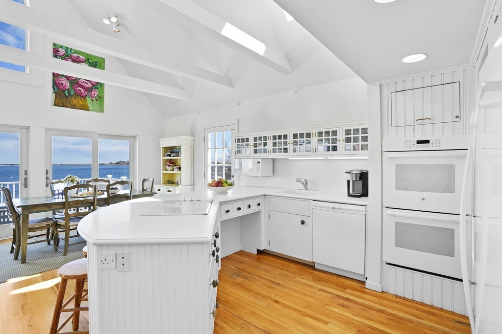 31 The Boulevard Edgartown, MA 02539 - Photo 16 of 39 a large white kitchen with cabinets