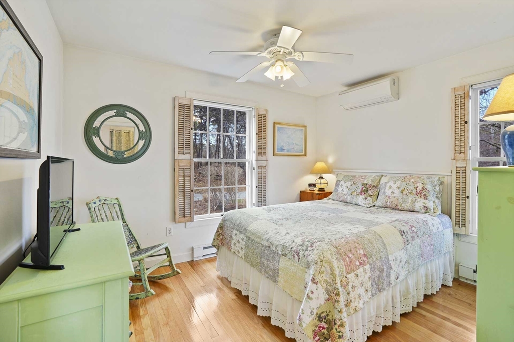 31 The Boulevard Edgartown, MA 02539 - Photo 19 of 39 a bedroom with a bed and a chandelier