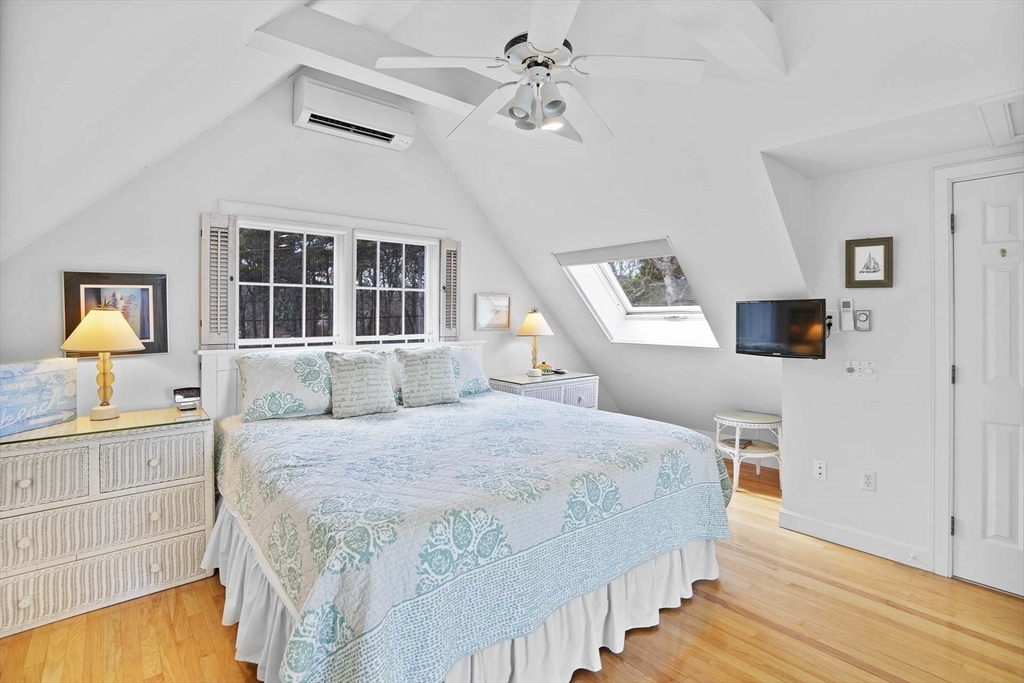 31 The Boulevard Edgartown, MA 02539 - Photo 26 of 39 a bedroom with a bed and a flat tv screen on dresser