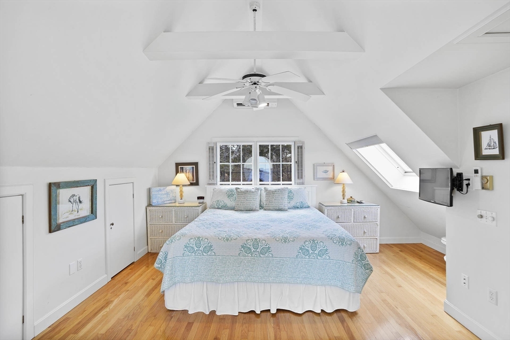 31 The Boulevard Edgartown, MA 02539 - Photo 28 of 39 a view of a bedroom with wooden floor and ceiling fan