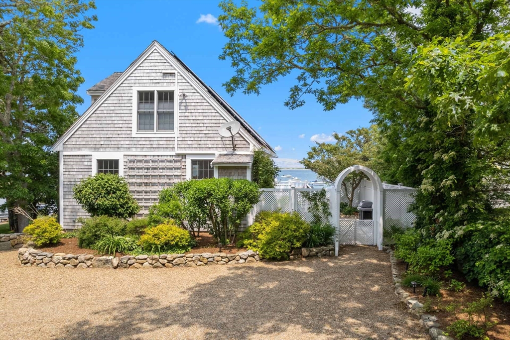 31 The Boulevard Edgartown, MA 02539 - Photo 34 of 39 a front view of a house with a yard and potted plants