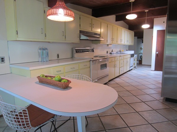94 Conant Road Lincoln, MA 01773 - Photo 3 of 14 a kitchen with stainless steel appliances kitchen island granite countertop a sink a stove a microwave cabinets and chairs