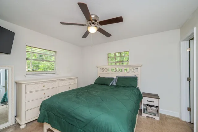 a living room with a bed furniture and a window