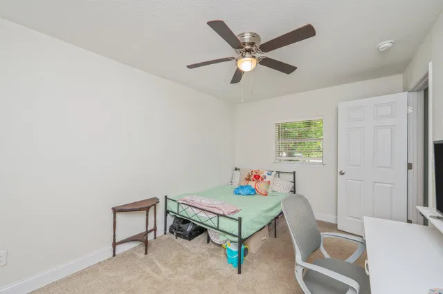 a bedroom with a bed and a desk