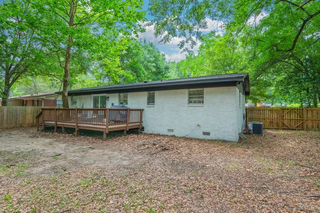 a view of a house with a yard and lake view