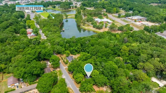 an aerial view of lake residential house with outdoor space and trees around