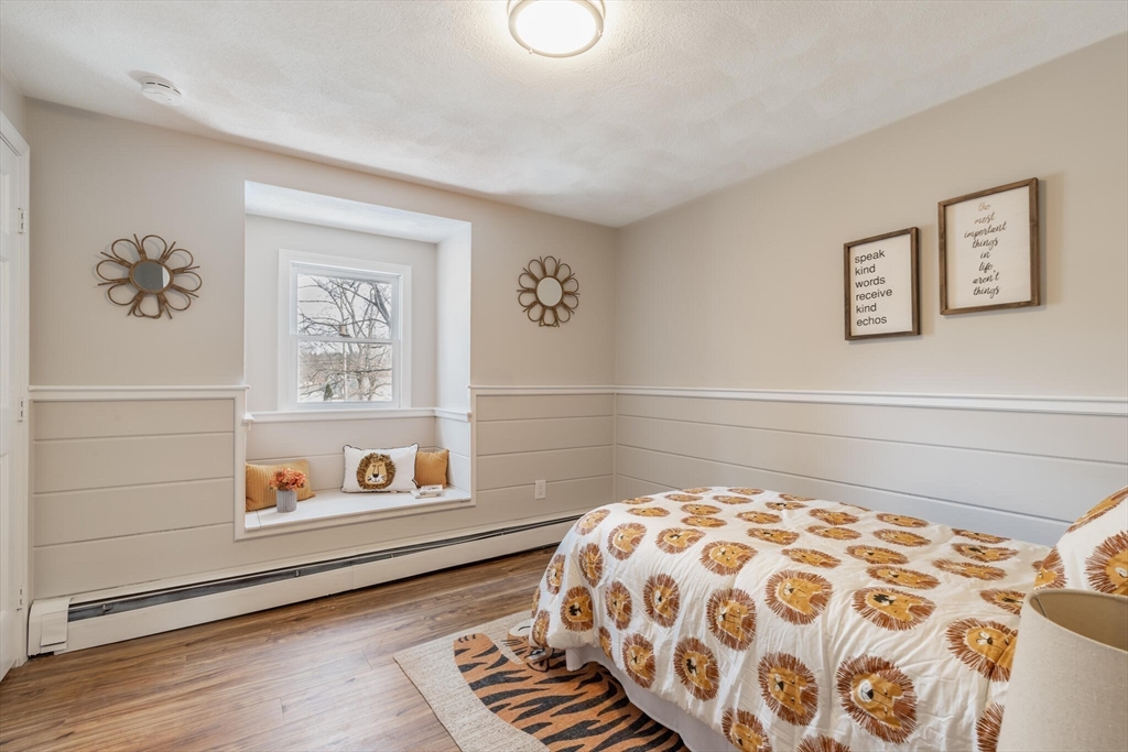 123 Lowell Road Pepperell, MA 01463 - Photo 12 of 30 a bedroom with a bed and a painting on the wall