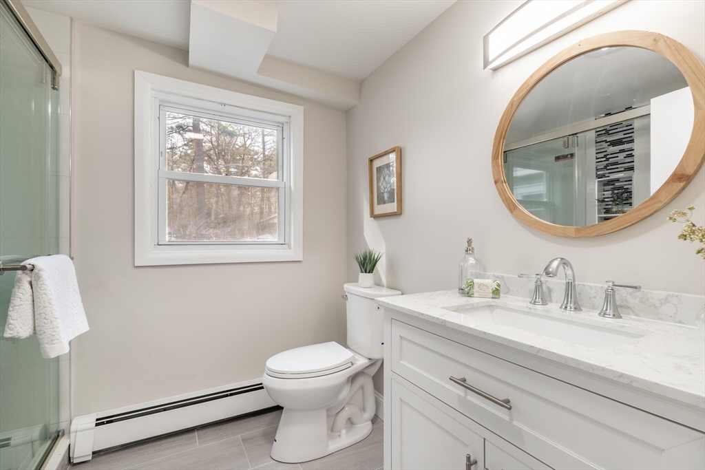 123 Lowell Road Pepperell, MA 01463 - Photo 16 of 30 a bathroom with a toilet a sink and mirror