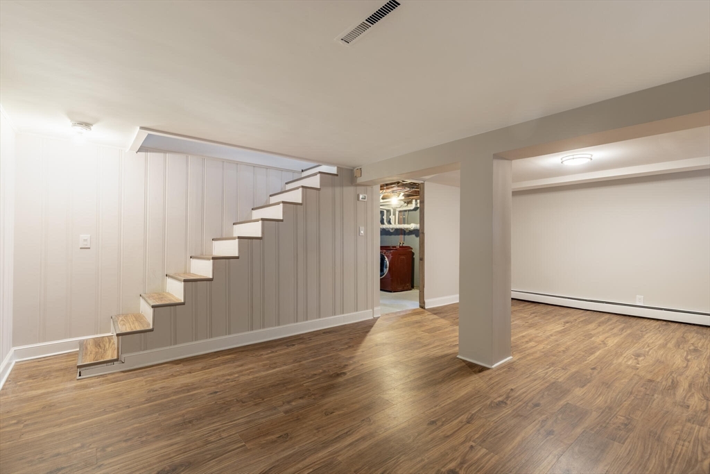123 Lowell Road Pepperell, MA 01463 - Photo 20 of 30 a view of an empty room with wooden floor and stairs