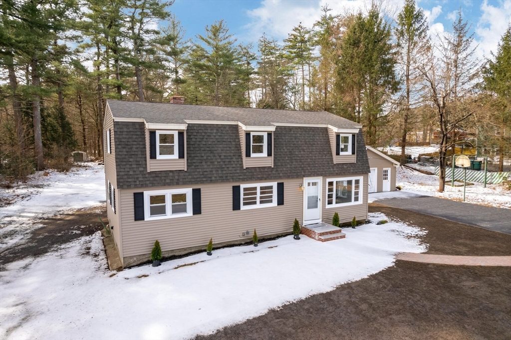 123 Lowell Road Pepperell, MA 01463 - Photo 25 of 30 a front view of a house with a yard and trees