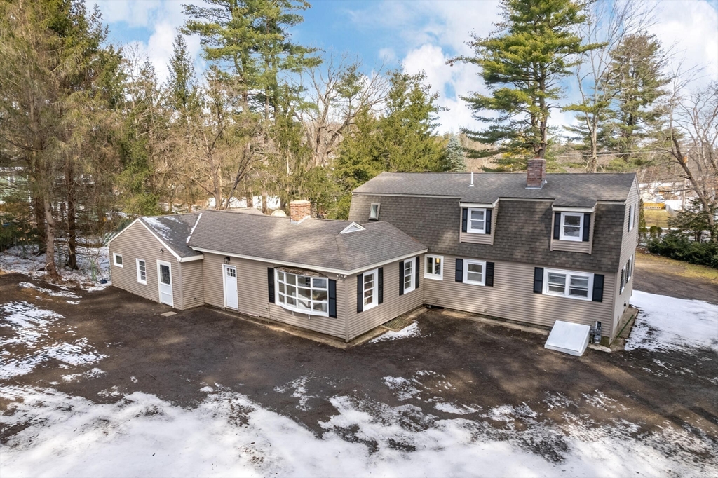 123 Lowell Road Pepperell, MA 01463 - Photo 26 of 30 a view of a large building with large tree and wooden fence