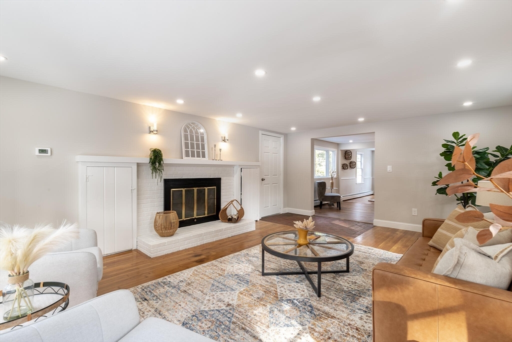 123 Lowell Road Pepperell, MA 01463 - Photo 8 of 30 a living room with furniture a fireplace and a flat screen tv