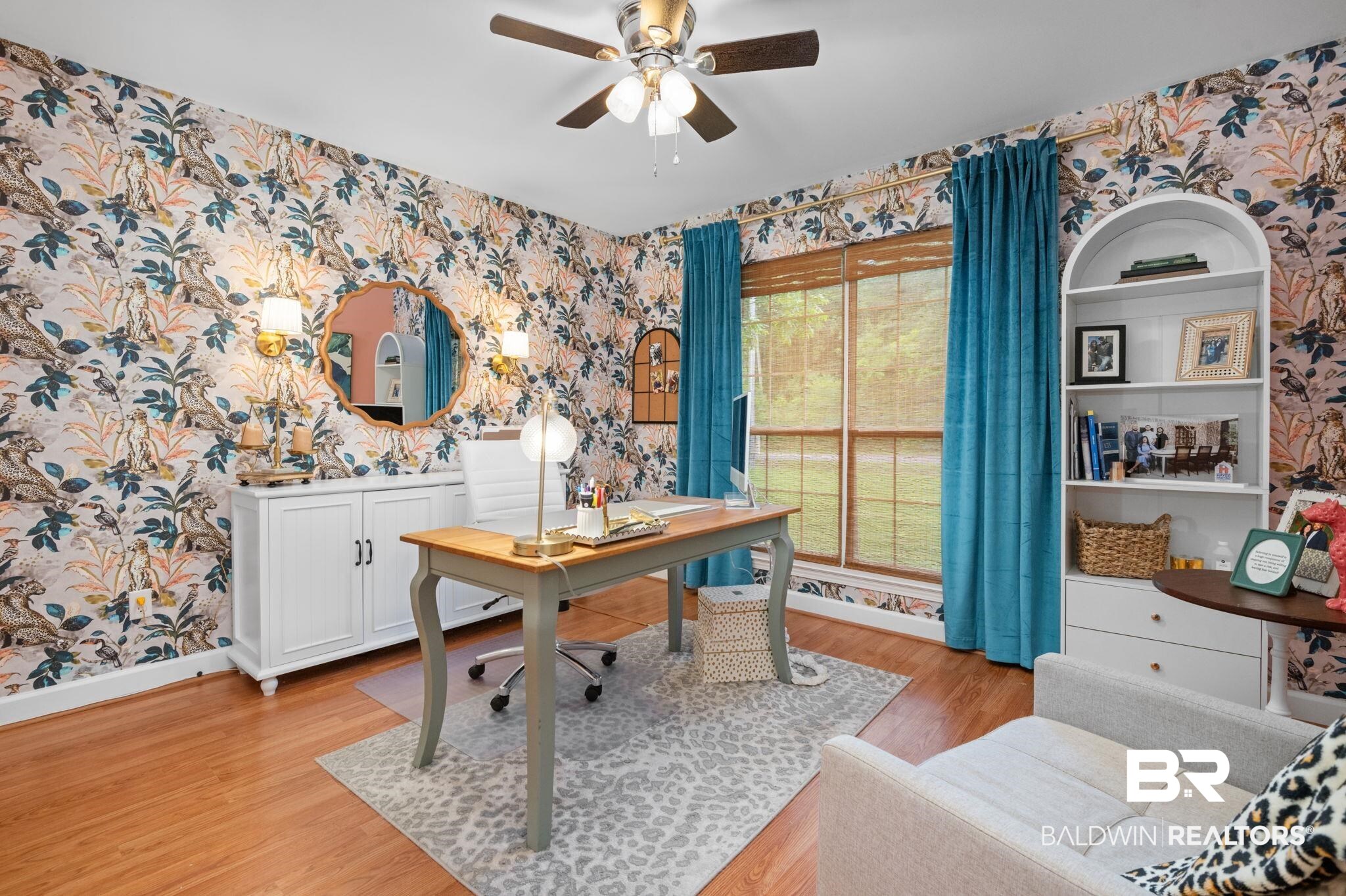 5936 Lundy Road Theodore, AL 36582 - Photo 19 of 32 Room featuring wood-finish flooring, patterned wallpaper, and a ceiling fan with integrated lighting